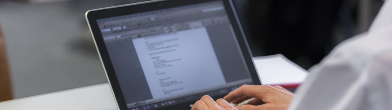 Student during a class taking notes on her labtop