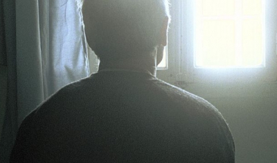 Picture of the back of a man staring at the window