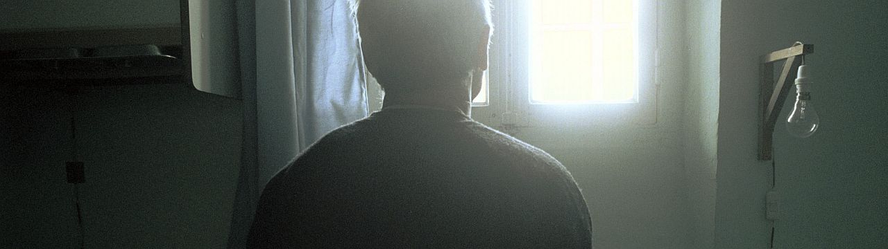 Picture of the back of a man staring at the window