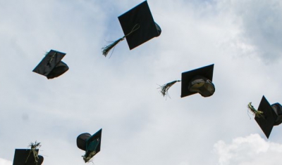 Gradutation hats thrown in the air