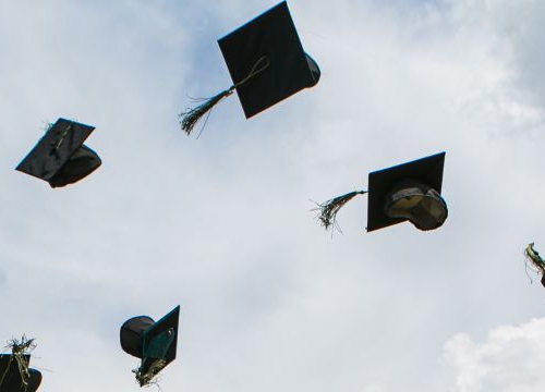 Graduation hats thrown in the air