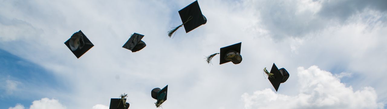 Graduation hats thrown in the air