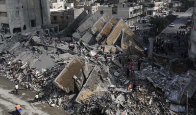 Gaza City, 2014. Palestinians check the remains of Al-Basha, a building that was destroyed by an Israeli air strike. 