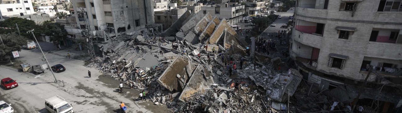 Gaza City, 2014. Palestinians check the remains of Al-Basha, a building that was destroyed by an Israeli air strike. 