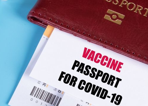 A photo with a passport and COVID-19 vaccine certificate