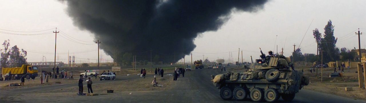 Smoke from a burning oil field rises into the air, Iraq, 2006