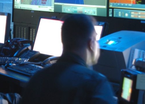 Joint Operations Center watch standers review the latest battle assessment while participating in Combined Joint Task Force Exercise (CJTFEX) 04-2 aboard the command ship USS Mount Whitney (LCC 20). 