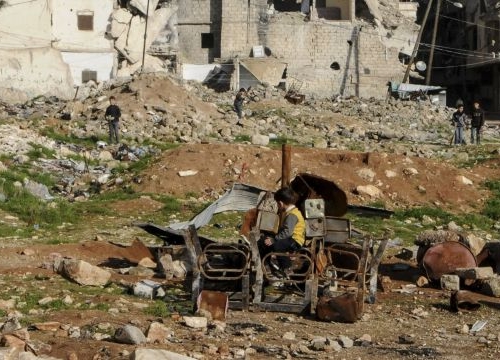  Outskirts of Aleppo. Kids playing with burnt chairs. 