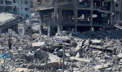  Palestinians inspect the damage following an Israeli airstrike on the El-Remal aera in Gaza City, October 2023.