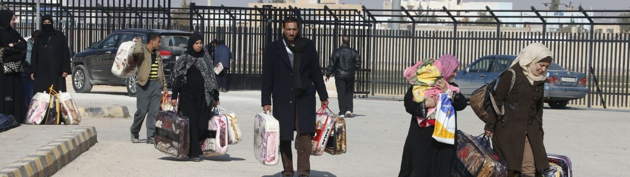 Syrian Refugees leave a blanket distribution center in Mafraq, Jordan.