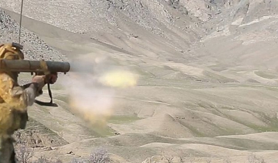 An U.S. Special Forces soldier assigned to Combined Joint Special Operations Task Force-Afghanistan fires a Carl Gustav recoilless rifle system after receiving small-arms fire during a clearance of Denasaro Kelay village in Mizan district, Zabul province,