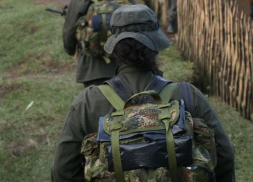 Colombia, 2010: Mountains in the Valle del Cauca region, between Santander de Quilichao et Popayan. FARC-EP (Revolutionary Armed Forces of Colombia) combattants walking next to native houses. 