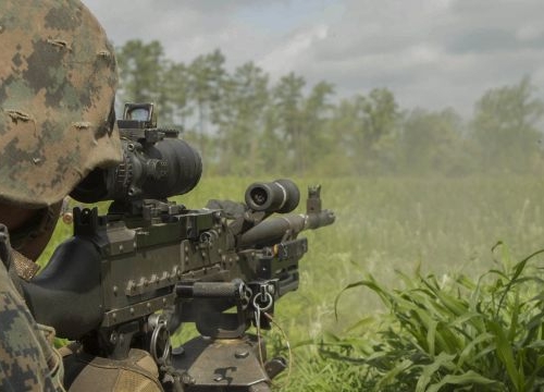 A U.S. Marine fires an M240B machine gun at a target during a company attack exercise at Fort A.P. Hill