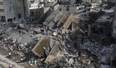 Gaza City. Palestinians check the remains of Al-Basha, a building that was destroyed by an Israeli air strike in 2014