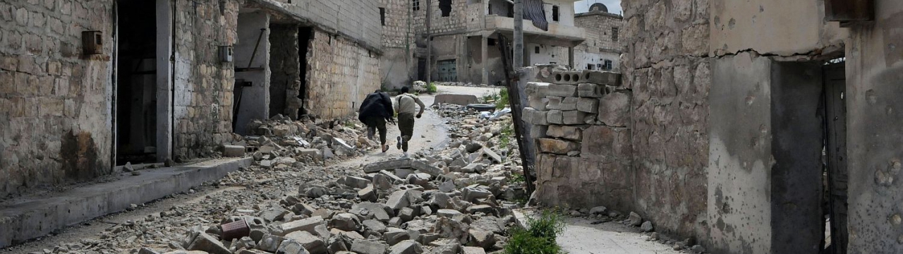 Syria, Aleppo, old city, at the frontline. Fighters of the Free Syrian Army run from possible sniper fire at a place that is exposed to government soldiers.