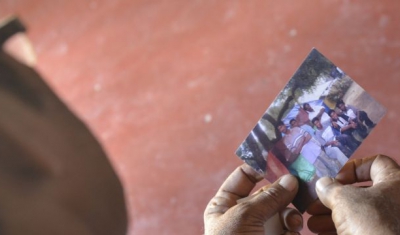 Sri Lanka, Mannar. A father looks at the last photo taken of his missing son. 