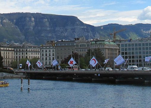 View of Geneva's Mont-Blanc Bridge with flags of the International Committee of the Red Cross (ICRC)