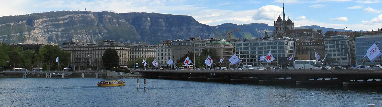 View of Geneva's Mont-Blanc Bridge with flags of the International Committee of the Red Cross (ICRC)