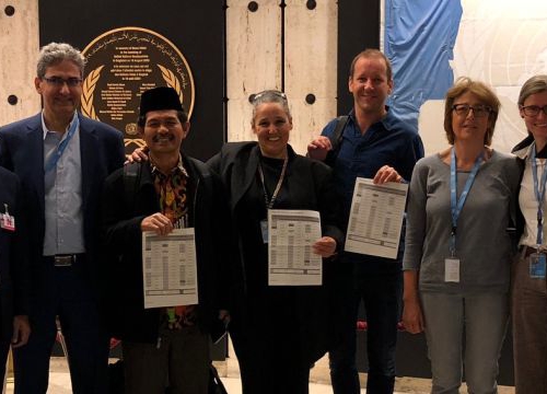 Academics and civil society holding the UN declaration after its adoption