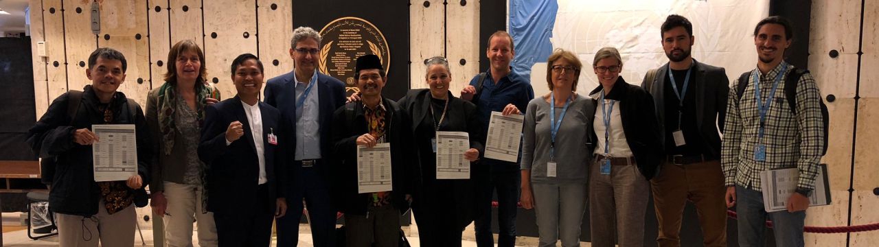 Academics and civil society holding the UN declaration after its adoption