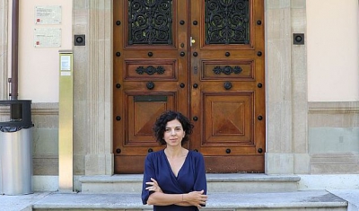 Nadia Oulaby in front of the entrance of Villa Moynier, the Geneva Academy Headquarters