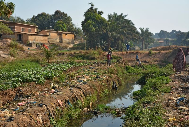 Women collecting water in a river, India