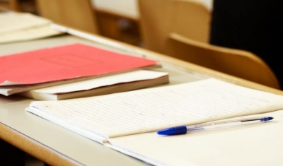 Desk with a folder and a pen