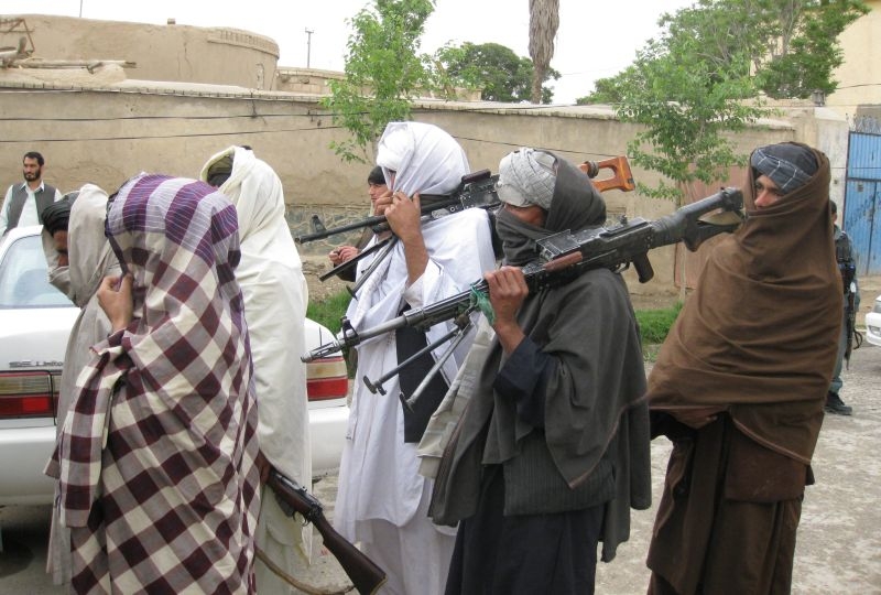 Taliban fighters meet with Government of the Republic of Afghanistan officials in Kandahar City, April 11, 2011, and peacefully surrendered their arms as part of the government's peace and reintegration process.