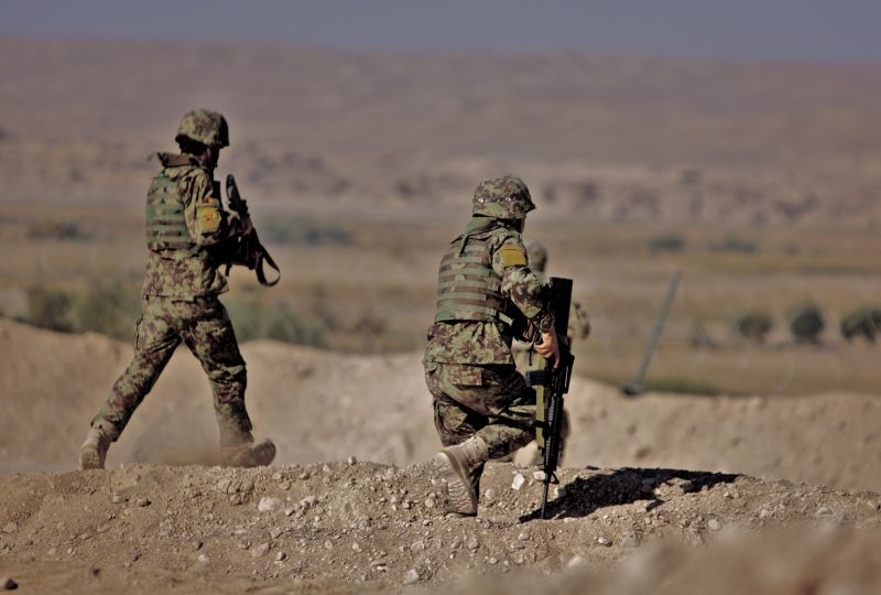 Soldiers from the 2nd Brigade, 215th Corps respond to a Taliban attack from the valley below Combat Outpost Nolay in Sangin, Helmand province. 