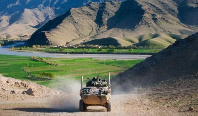 An Australian service light armored vehicle drives through Tangi Valley, Afghanistan