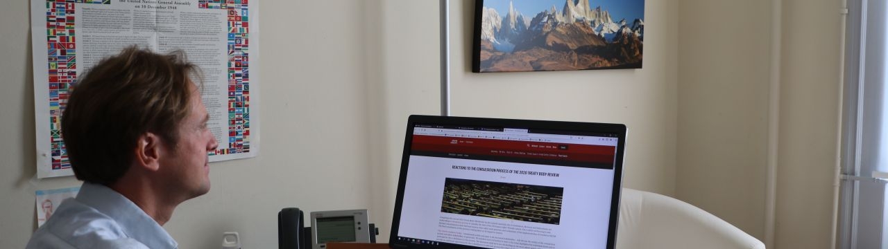 Felix Kirchmeier, Executive Director of the Geneva Human Rights Platform, in front of his computer