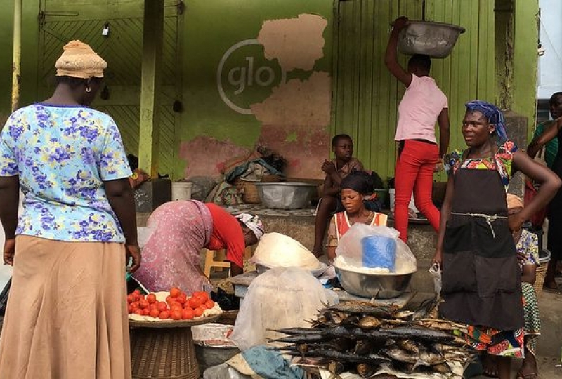 Women in a Ghana market sell vegetables and smoked fish