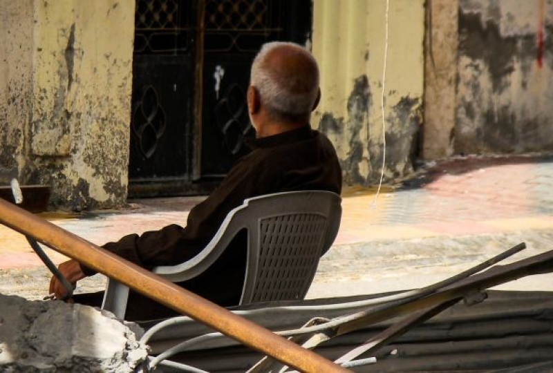 A man sits on a chair in Raqqa Syria