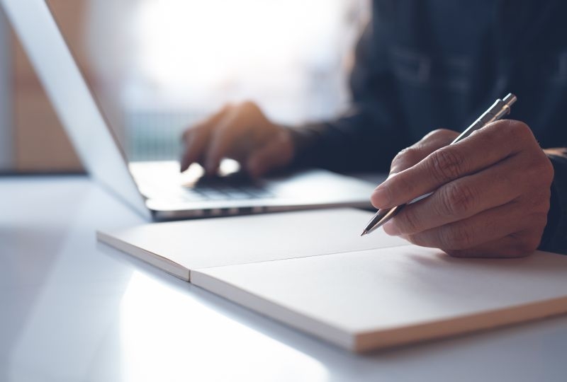 A person typing on a laptop