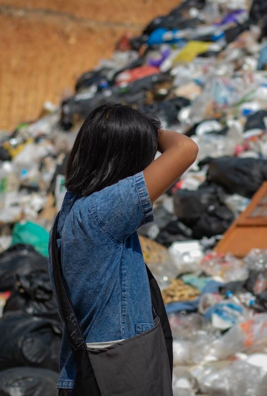 Young girl in an open dump