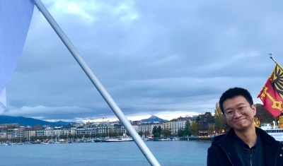 Tong Li on the Mont-Blanc Bridge with the Geneva Academy flags