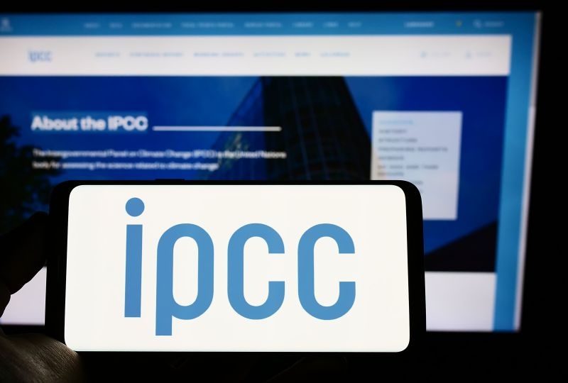 Stuttgart, Germany - 09-25-2022: Person holding mobile phone with logo of Intergovernmental Panel on Climate Change (IPCC) on screen in front of web page. Focus on phone display.
