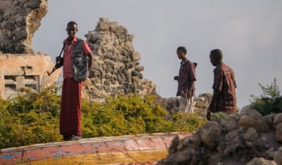 Armed Somali men stand guard over-looking Lido Beach 06 August 2012, in the Kaaraan Districtl in the Somali capital Mogadishu. 