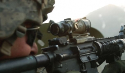 A U.S. Army Soldier with 1st Battalion, 32nd Infantry Regiment, 10th Mountain Division, fires an M-4 rifle during a gun battle with insurgent forces in Barge Matal, during Operation Mountain Fire, July 12. 