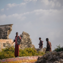 Armed Somali men stand guard over-looking Lido Beach 06 August 2012, in the Kaaraan Districtl in the Somali capital Mogadishu. 