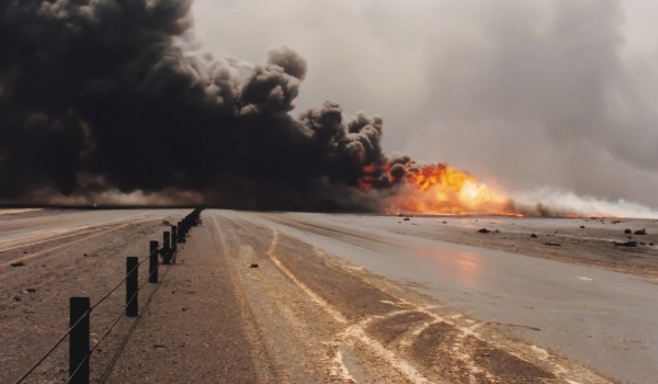 Road through oil well burning in field with oil slick, Kuwait
