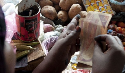 Somalia, Bakool region, Hudur village. Woman selling products at market.