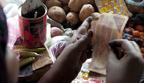 Somalia, Bakool region, Hudur village. Woman selling products at market.