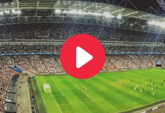 Play button with screenshot of a football stadium